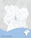 Blue-gray detailed map of Cote d`Ivoire administrative divisions and location on the globe