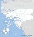 Blue-gray detailed map of Guinea-Bissau administrative divisions and location on the globe