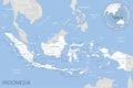 Blue-gray detailed map of Indonesia administrative divisions and location on the globe