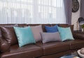 Blue and gray pillows on leather sofa in modern living room Royalty Free Stock Photo