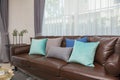 Blue and gray pillows on leather sofa in modern living room Royalty Free Stock Photo