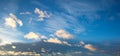 blue and gray sky background with floating lighted cumulus clouds Royalty Free Stock Photo