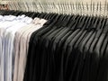 Blue, gray with white dot and black shirt on hangers in shopping Royalty Free Stock Photo