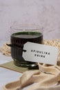 Blue-green algae Chlorella and spirulina powder drink with paper note text SPIRULINA DRINK. Super powder. Natural