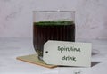 Blue-green algae Chlorella and spirulina powder drink with paper note text SPIRULINA DRINK. Super powder. Natural