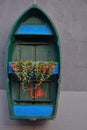 Blue-green boat hanging on a wall