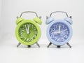 Blue and Green color Alarmclock put together on white background