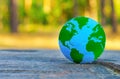 Blue and Green Globe on a Tree Stump Royalty Free Stock Photo