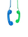 Blue and green phones hanging from a cable