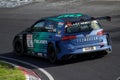 Blue and green race car driving on a track, perfect for any motorsport or racing-related visuals
