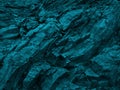 Blue green rock background. Dark turquoise toned mountain surface. Royalty Free Stock Photo