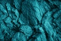 Blue green rock texture. Toned the rough surface of the mountain. Close-up. Dark teal stone background with space for design. Royalty Free Stock Photo