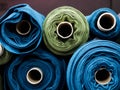 Blue and green rolls of knitted fabric. Woven factory or warehouse