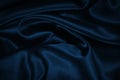 Blue green silk satin fabric. Dark teal color elegant background. Liquid wave or silk wavy folds. Royalty Free Stock Photo