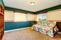 Blue green sitting room with beige carpet and colorful sofa