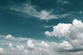 Blue-green sky with heavy cumulus clouds and birds silhouettes