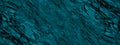 Blue green stone background. Dark turquoise toned monochrome rock texture. Close-up. Royalty Free Stock Photo