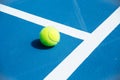 Blue and green tennis court surface,Tennis ball on the field Royalty Free Stock Photo