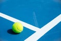 Blue and green tennis court surface,Tennis ball on the field Royalty Free Stock Photo