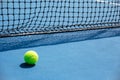 Blue and green tennis court surface,Tennis ball on the field Royalty Free Stock Photo