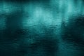 Blue green water surface. Night. Small waves. Ripples. Reflection of light. Dark teal water background. Royalty Free Stock Photo