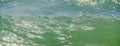 Blue, green water waves, Black Sea sandy shore, seaside with water foam, lather, close up