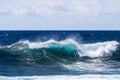 Blue-green wave breaking on Hawaii`s Big Island. Foam on top; deep blue Pacific ocean in background. Royalty Free Stock Photo