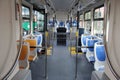 Blue and grey seats for passengers in saloon of empty city bus Royalty Free Stock Photo