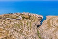 Blue Grotto in Malta. Pleasure boat with tourists runs. Natural arch window in rock. Aerial top view. Royalty Free Stock Photo