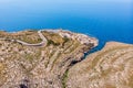 Blue Grotto in Malta. Pleasure boat with tourists runs. Natural arch window in rock. Aerial top view. Royalty Free Stock Photo