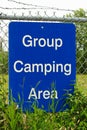 A blue group camping area sign on a fence Royalty Free Stock Photo