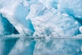 Blue growler piece of iceberg with reflection in calm water. Arctic ocean Royalty Free Stock Photo