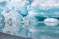 Blue growler piece of iceberg with reflection in calm water. Arctic ocean Royalty Free Stock Photo