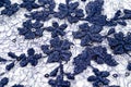 A blue guipure with volumetric embroidery of flowers and sequins, photographed in close-up