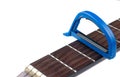 Blue guitar capo and guitar isolated on white background