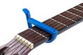 Blue guitar capo and guitar isolated on white background Royalty Free Stock Photo