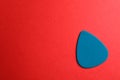 Blue guitar pick on color background Royalty Free Stock Photo
