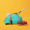 Blue gym bag and sports accessories on yellow background Royalty Free Stock Photo