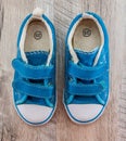 Blue gym shoes on a wooden background. View from above. Royalty Free Stock Photo