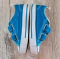 Blue gym shoes on a wooden background. View from above. Royalty Free Stock Photo