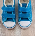 Blue gym shoes on a wooden background. View from above. Royalty Free Stock Photo