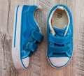 Blue gym shoes on a wooden background. View from above. Royalty Free Stock Photo