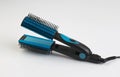 Blue hair straightener with comb isolated on white Royalty Free Stock Photo
