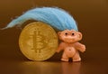 Bitcoin golden coin with hairy troll figure stock images Royalty Free Stock Photo