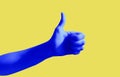 Blue hand gesture on yellow background poster. Thumb up. Like social web