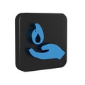 Blue Hand holding a fire icon isolated on transparent background. Black square button. Royalty Free Stock Photo