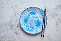 Blue hand painted ceramic serving plate with wooden chopsticks on side Royalty Free Stock Photo