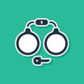 Blue Handcuffs icon isolated on green background. Vector
