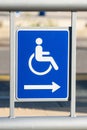 Blue handicap sign with an arrow