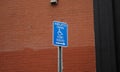 Blue handicap sign on the street - a symbol for mobility aid for people with disabilities